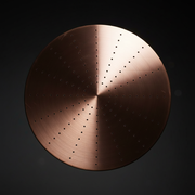 Close-up of copper rain shower head nozzles with moody studio lighting
