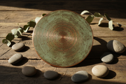 Copper rain shower head with patina finish on rustic wood with natural elements