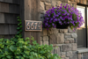 Handmade dark patina copper address plaque with 4 house numbers - lifestyle on home exterior